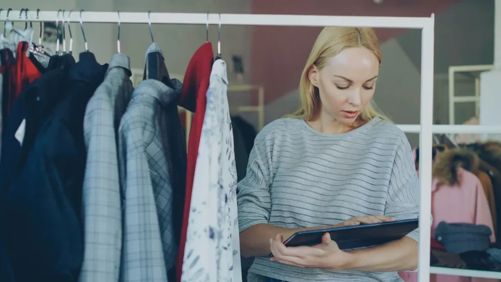 Small business owner checking inventory on a tablet, illustrating E-2 visa requirements for a U.S. business