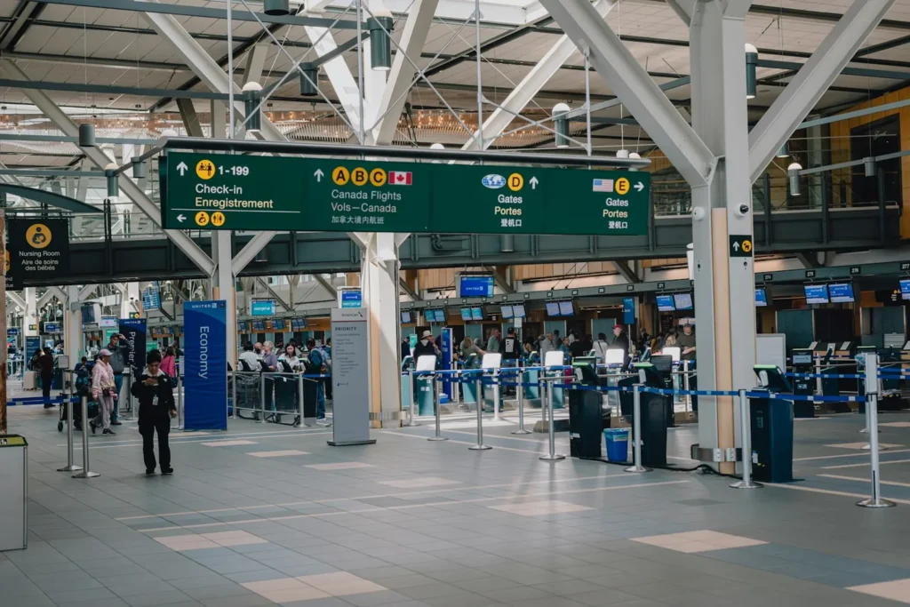 Travelers in the Vancouver International Airport terminal, representing TN visa requirements for Canadians